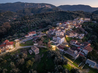 Fototapeta na wymiar Greece, mountain village Drosato aerial panoramic view, Corfu. Traditional tile roof and stone wall buildings, forest trees, winter
