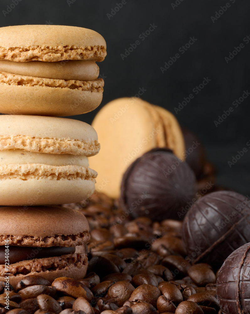 Poster stack of multi-colored macarons on a background of coffee beans, black background