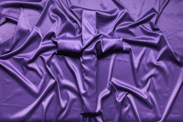 Cross under purple cloth as background. Good Friday concept