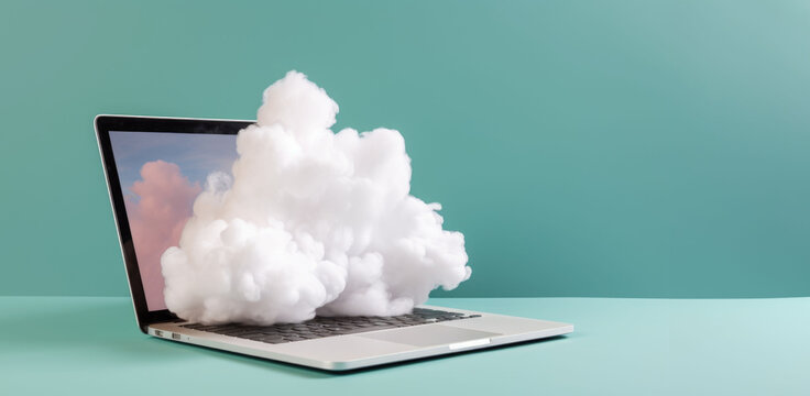 Cloud computing technology concept with a cloud made of cotton wool on the open laptop on isolated blue background