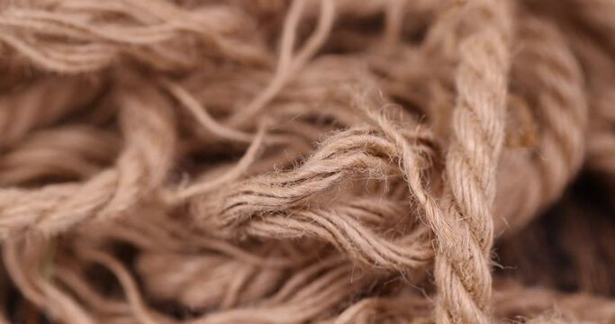 rough linen rope close-up, rough rope on a wooden table