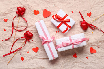Gift boxes and hearts on crumpled paper. Valentine's Day celebration