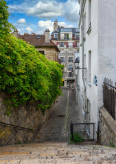 Typical street in Montmartre with staircase in Paris, France. Cozy cityscape of Paris. Architecture...