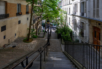 Typical street in Montmartre with staircase in Paris, France. Cozy cityscape of Paris. Architecture and landmarks of Paris.