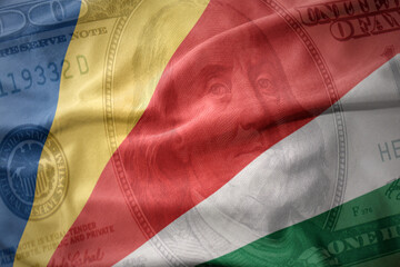 waving colorful flag of seychelles on a american dollar money background. finance concept.