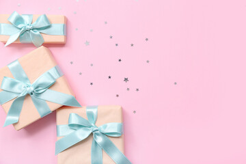 Gift boxes and confetti on pink background. International Women's Day