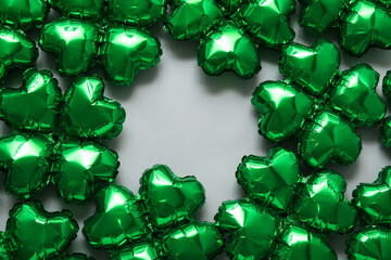 Frame made from balloons in shape of clover on grey background.  St. Patrick's Day celebration