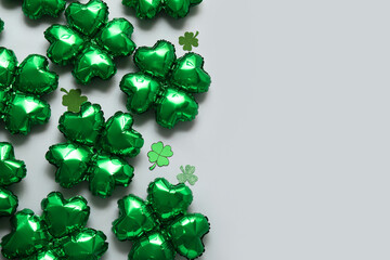 Balloons in shape of clover on grey background. St. Patrick's Day celebration