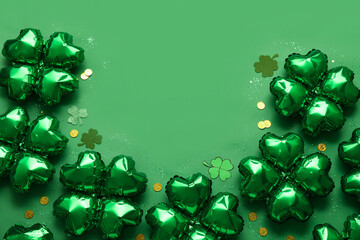 Balloons in shape of clover and coins on green background. St. Patrick's Day celebration