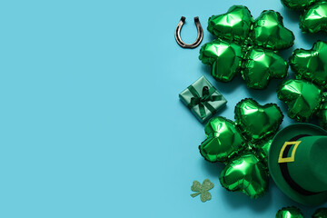 Balloons in shape of clover, horseshoe, gift box and leprechaun's hat on blue background. St....