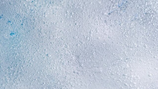 Super Slow Motion Shot of Bubbling Light Blue Background at 1000fps.