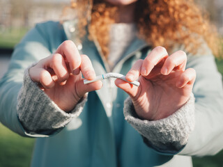 Close-Up of Female Hands Bending a Cigarette, Health Choice Concept
