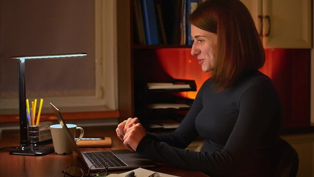 A young professional woman conducts a video interview on her laptop. She demonstrates professionalism, confidence, and enthusiasm as she going through the interview process. 
