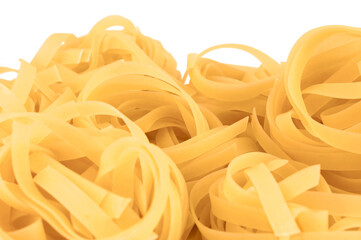 Traditional fettuccine ribbons pattern background, large detailed isolated horizontal raw dry long uncooked egg pasta macro closeup, natural golden texture perspective, blank empty white copy space - 723427280