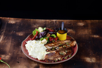 dish with mashed potato fish fillet and fried tilapia salad taste