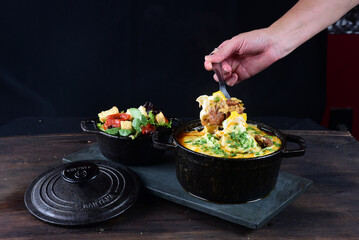 meatballs covered with sauce and melted cheese and salad