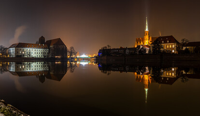 View of Collegiate Church of the Holy Cross in Wroclaw in the night, Poland - obrazy, fototapety, plakaty