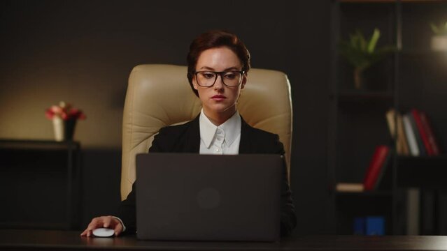 The business woman sending emails for partners and colleagues using laptop in office. Business lady control organizing her tasks in notebook application. Smart management system