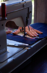 closeup of sewing machine with hands upright