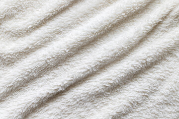 Fototapeta na wymiar White plush fabric throw. Warm blanket background