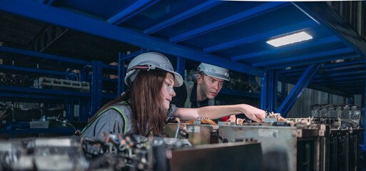 Engineers Inspecting Robotic Components in Warehouse.