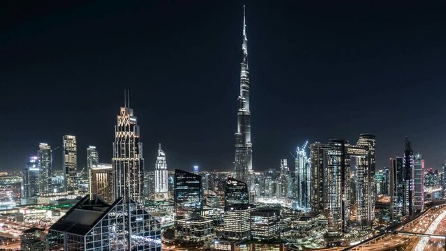 Time lapse of Burj Khalifa in Dubai Downtown skyline and fountain, United Arab Emirates or UAE. Financial district and business area in smart urban city. Skyscraper and high-rise buildings at night