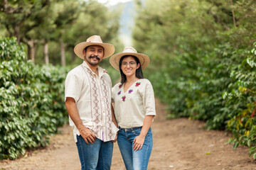 farmers smile happily in the middle of the coffee field.