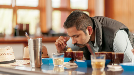 Barista tests the quality of the coffee, perceiving the aroma of the drink.
