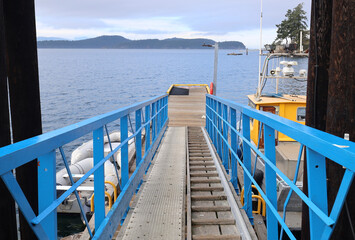 Perspective of blue walkway to marine floating dock