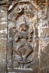 Fototapeta na wymiar Bas relief of Hindu deity Sandstone sculpture. Ruins of ancient sculptures carved in the walls of Kanchi Kailasanathar temple in Kanchipuram, Tamilnadu.