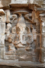 Bas relief of Hindu deity Sandstone sculpture. Ruins of ancient sculptures carved in the walls of Kanchi Kailasanathar temple in Kanchipuram, Tamilnadu.