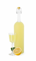 Tasty limoncello liqueur, half of lemon and green leaf isolated on white