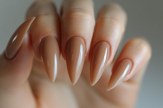 Closeup to woman hands with elegant vibrant colors manicure. Beautiful nude manicure on long almond shaped nails. shade nail manicure with gel polish at luxury beauty salon