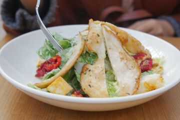 Caesar Salad in a bowl on table,