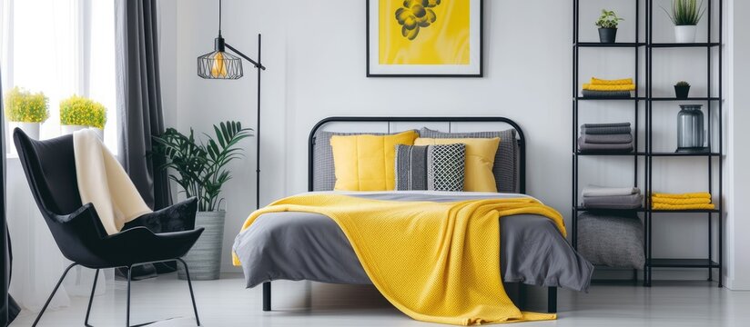 Spacious bedroom with yellow accessories featuring a sleek black chair next to a metal shelf and bed.