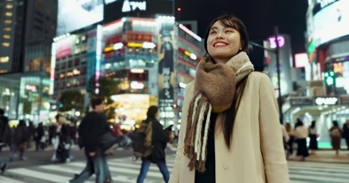 Night, walking and Japanese woman in town for exploring on vacation, adventure or holiday. Happy, travel and beautiful Asian female person by public transport for sightseeing on weekend trip in city