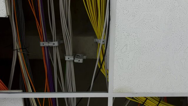Bottom up shot showing modern network cabling in ceiling of modern company,close up dolly