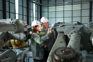 Engineering Professionals Assessing Machinery in a Robotic Workshop