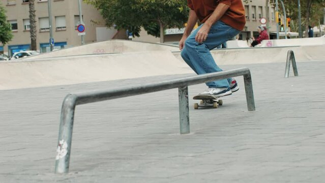 Young skater making nollie 360 flip jump, performing kickflip trick, skateboarder training in skatepark, making tricks, slides and flips, professional extreme sport athlete training ride on skateboard
