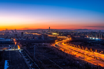 Beijing evening city lights traffic flow CBD building complex overpass