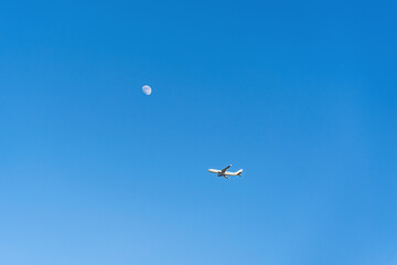 airplane flying over sky moon