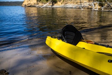 yellow canoe and kayak on a sandy beach in Australia in summer. kayaking on the sea in tasmania