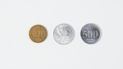three variants of Indonesian rupiah coins.