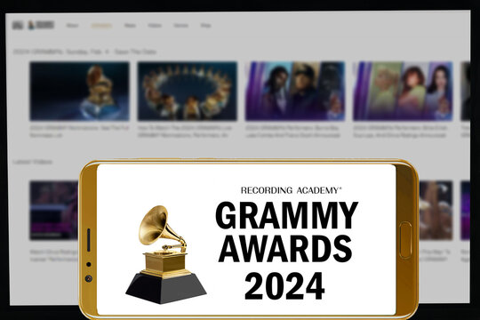 MADURAI, INDIA, 31ST JANUARY 2024: Grammy awards 2024 logo in mobile screen and their website in blurred background.