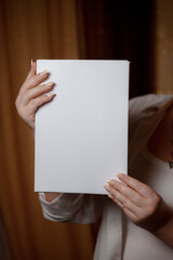 Creative start: a blank piece of paper waiting for inspiration. White sheet of paper in female...