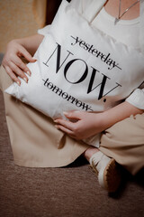 Pillow with the inscription: now. You need to live your life today. Motivational inscription to act...