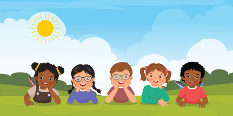 Group of multi ethnic kids lying on the grass together
