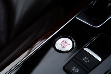 Start engine stop button Interior of modern luxury car. Details of automatic transmission gear...
