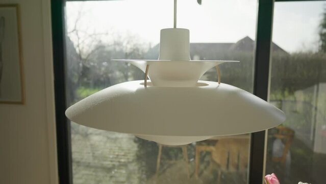 Modern white pendant light in a bright interior.
