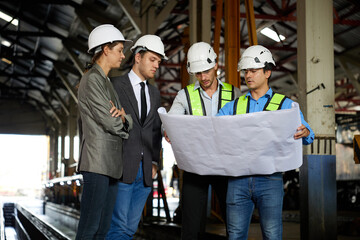 engineers and businesspeople talking about work or project on a construction site